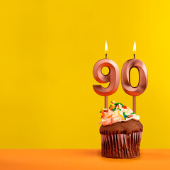 Candle with flame number 90 - Birthday card on yellow background