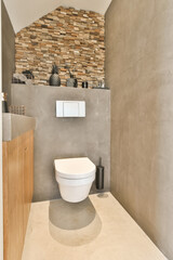 a modern bathroom with stone wall and wooden cabinetd toilet in the corner, which is also used as a shower room