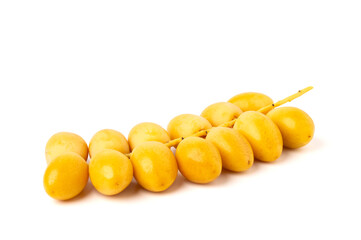 Fresh yellow date palm fruit. isolated on white background.
