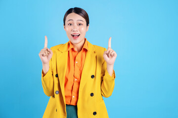 Photo of young Asian businesswoman with colorful suit on background