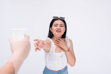 A desperately thirsty asian woman reaches out to someone holding a cup of water. A lady pleading...