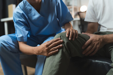 A physiotherapist or medical professional is doing counseling and physiotherapy on the knee and leg area at the patient's injured ward. stretching exercise causes pain, health insurance.