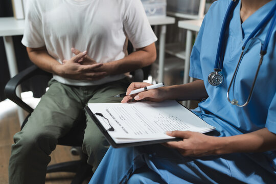 A female doctor or a medical specialist asks a patient about abdominal pain, dysentery from eating disorders. Unclean, undercooked, causing pain. The concept of rejuvenation therapy, treatment
