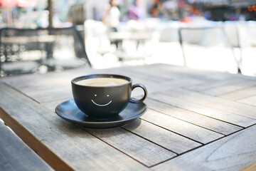 black coffee cup with smile shape design on it 