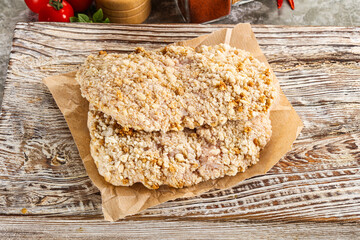 Breaded raw breaded meat schnitzel