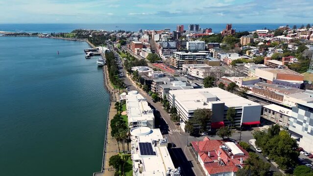 Drone aerial CBD city Newcastle Harbour Honeysuckle wharf Nobby's beach building Hunter River architecture NSW Australia 4K