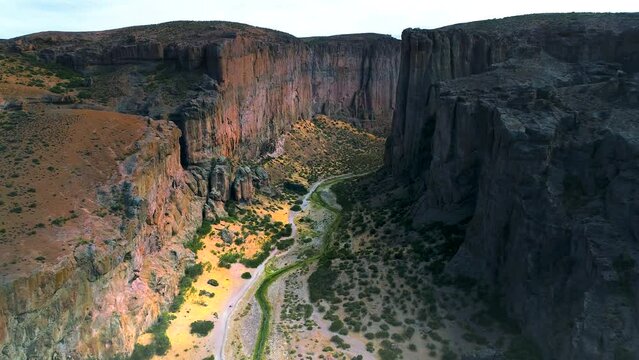 Canyon from a drone going down into it. This canyon if facing the big piedra parada in the province of Chubut in Argentina. This canyon is more than 200 meters deep.