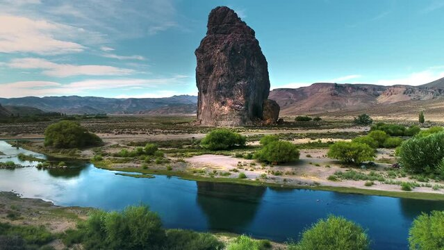 The big piedra parada almost 250 meters high in Argentina, province of Chubut. The river is the chubut. Drone shot like a crane shot.