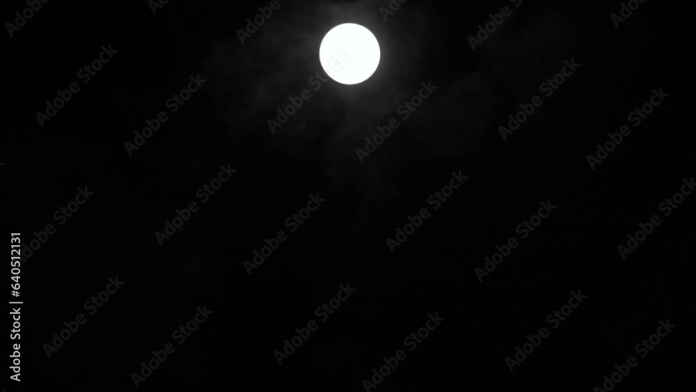 Wall mural timelapse of full moon rising vertically in dark black sky, moon lapse