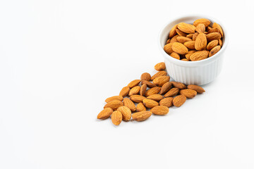 Almonds in a white bowl with a white background