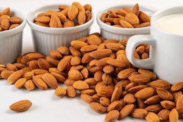 Studio shot of bowls with almonds and vegetable milk