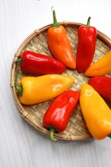 Vibrant chilli peppers. Assorted colorful varieties of hot and sweet peppers or chilies on a farm background. copy space. 