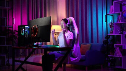 Excited Asian Teen Girl Gamer Celebrates Victory While Playing Video Game On Computer
