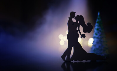 Black silhouettes of pair dancers performing. Man and woman are dancing with white backlight....