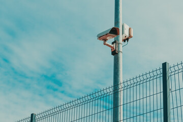 Prison yard surveillance security cameras mounted on the post