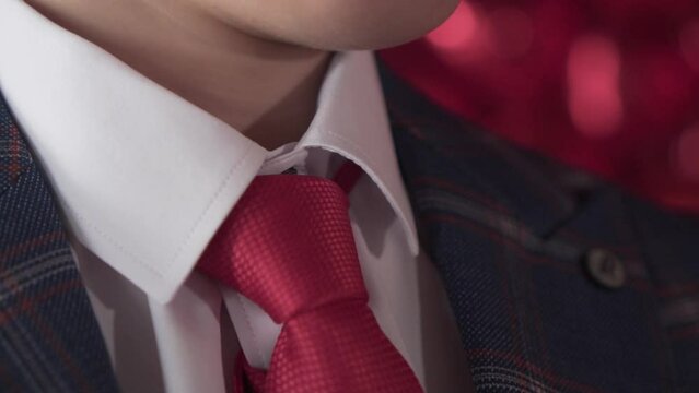 Red tie close-up. Male businessman in a jacket, white shirt and red tie