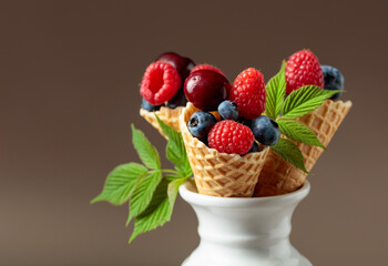 Fresh berries in waffle cones.