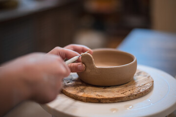 girl hands, pottery studio and painting cup in workshop for sculpture