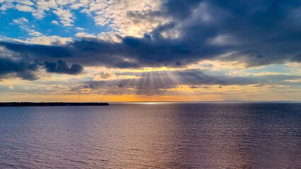 The sunbeam scene with the tropical summer sky scene and wave water seashore background
