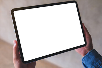 Mockup image of a woman holding digital tablet with blank white desktop screen
