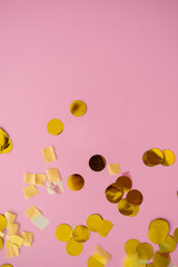 Confetti on pink background in a festive flat-lay