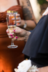 Guest enjoying glass of champagne at elegant wedding