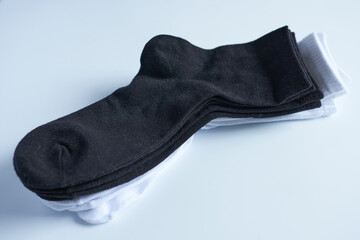 Black and white socks on a white background, close-up, top view