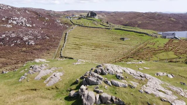 Drone shot of the 'Dun Carloway Broch' on the west coast of the Isle of Lewis, part of the Outer Hebrides of Scotland. The broch is a tourist attraction first built around 100AD.