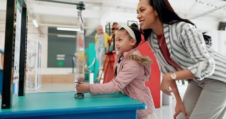 Education, science and a teacher with her student at a fair, spinning a color wheel together for learning or development. Study. children and a girl at school with an educator for learning or growth