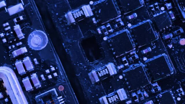 Close-up metal surface digital microcircuit technological background blue neon light, tracking shot, computer components macro close up. PC chip, cpu, circuits.