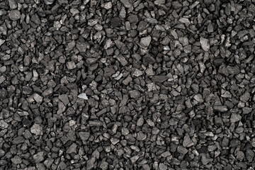 Ion-exchange Anthracite for water softening beads or granules texture background. Anthracite water filter for residential drinking or industrial texture,top view