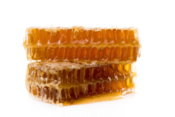 Bee products with honey and sweet honeycomb isolated on white background