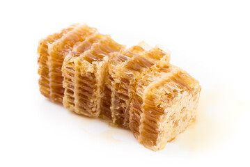 Fresh honey in the comb close-up isoleted on white background.