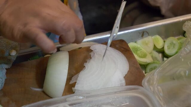 thailand night market street food booth cutting onion