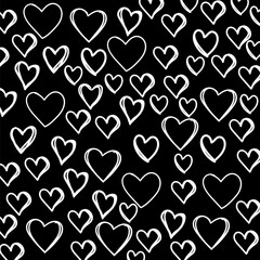 Seamless pattern with hand drawing hearts. Ornament for Valentine's day. Ink illustration. Isolated on black background.