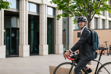 Young manager coming to the office by bike