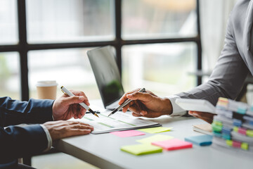 Young colleagues discussing business and price chart analyzes business people on the table great in modern coworking office teamwork concept. Calculate personal tax for customers