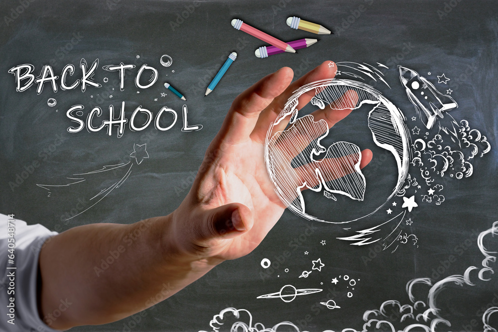 Poster close up of businessman hand holding abstract back to school sketch with pencils and rocket on chalk
