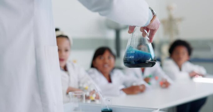Science, education and hand of a teacher for a chemical reaction in class with student children. School, learning or study and kids in a classroom research or an experiment with a scientist closeup