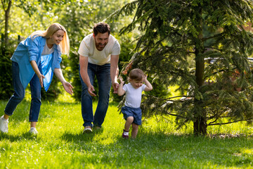Fototapeta premium Cute young family spending time together in the park