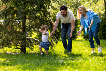 Fototapeta premium Cute young family spending time together in the park
