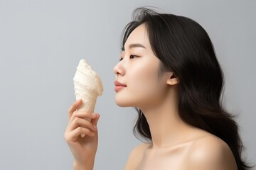 Asian Woman Eats Vanilla Ice Cream