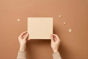 Female hand holds blank square paper mockup envelope red, golden stars confetti, gift boxes on beige background. Flat lay, top view, copy space, minimalist. Christmas and New Year concept - 640555944