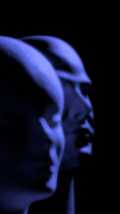 blurred mannequin heads illuminated by blue theatrical light
