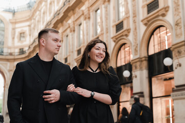 Young stylish man and woman in Vittorio Emanuele Gallery in Milan