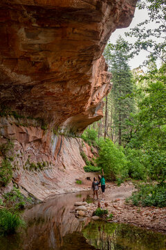Young couple discovering wonders on rocky trail vertical