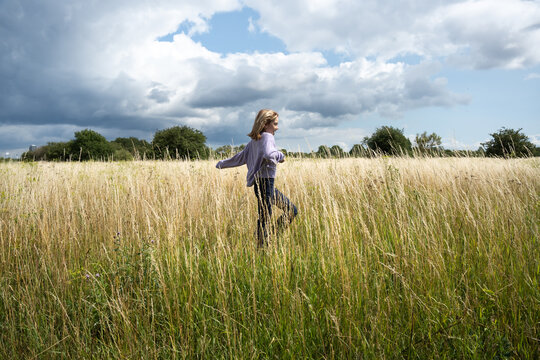 Young Girl In Copenhagen Looking for Wild Flowers