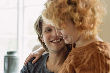 Delighted couple embracing at home during date