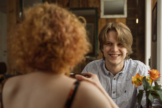 Happy young man sitting with a female