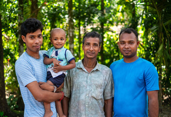 Male members of different ages of a south asian family are in a park